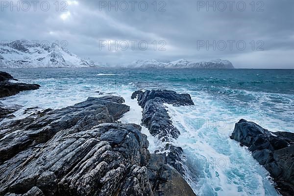 Waves of Norwegian sea crushing at rocky coast in fjord. Vikten