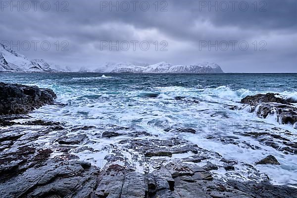 Waves of Norwegian sea crushing at rocky coast in fjord. Vikten