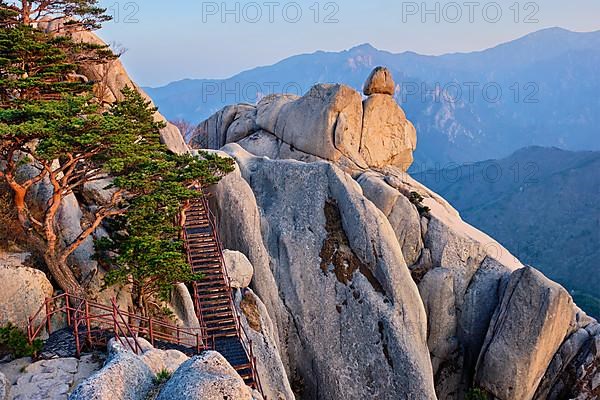 View of stones and rock formations from Ulsanbawi rock peak on sunset with staircase. Seoraksan National Park