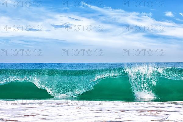 Big wave in ocean with blue sky