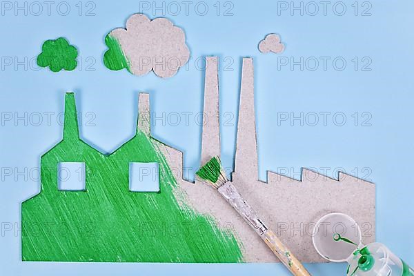 Greenwashing concept with cardboard factory being painted green