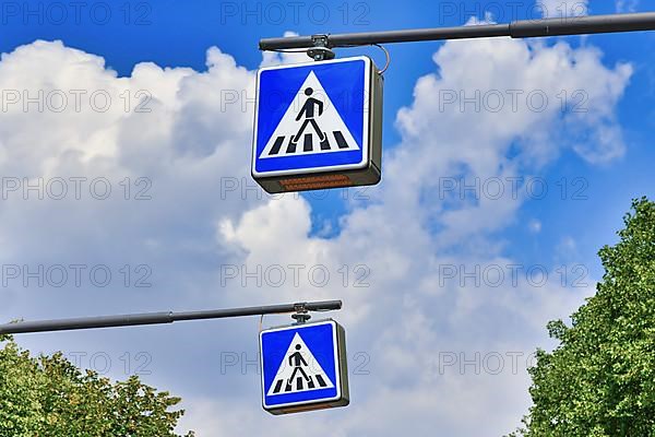 Zebra pedestrian crossing street traffic signs in front of sky