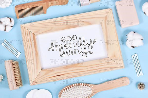 Eco friendly living concept with wooden beauty and hygiene products like comb and soap on blue background