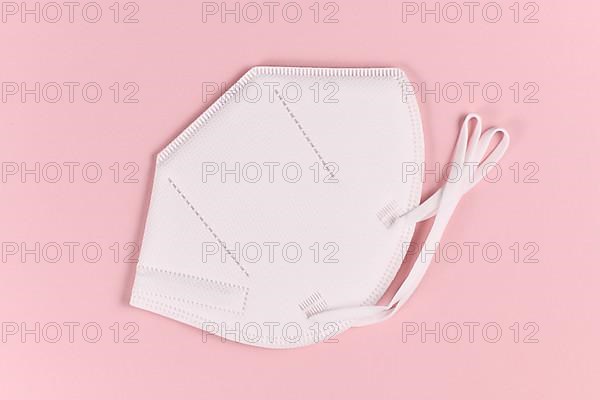 Medical FFP2 respirator mask on pink background