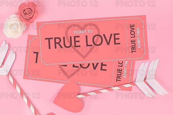 Valentines day concept with True Love ticket and cupid arrows on pink background