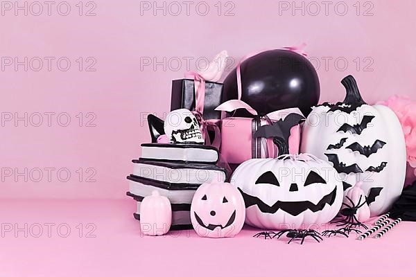 Pink Halloween decor with black and white pumpkins