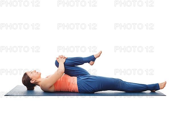 Woman doing Hatha Yoga asana Ardha pawanmuktasana