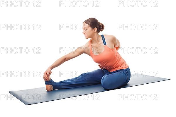 Woman doing Hatha yoga asana Ardha baddha padma paschimottanasana