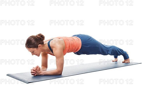 Woman doing Yoga asana Chaturanga dandasana variation