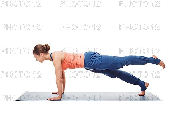 Woman doing Hatha yoga asana Utthita chaturanga dandasana