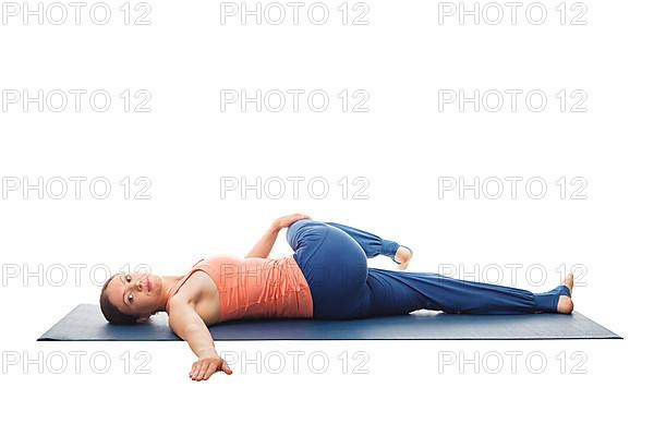 Woman doing Yoga asana Parivrtta ardha pawanmuktasana