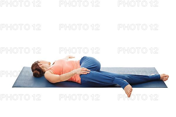 Woman doing Yoga asana Parivrtta ardha pawanmuktasana