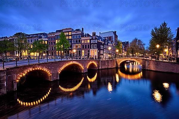 Night view of Amterdam cityscape with canal