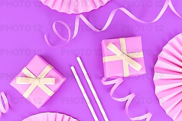 Violet party flat lay with pink gift boxes