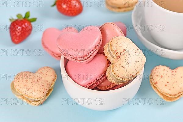 Bowl with heart shaped French macaron sweets
