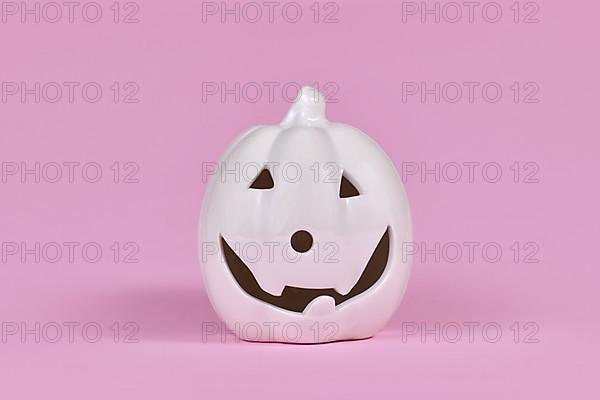 Single Pumpkin decoration with face on pink background