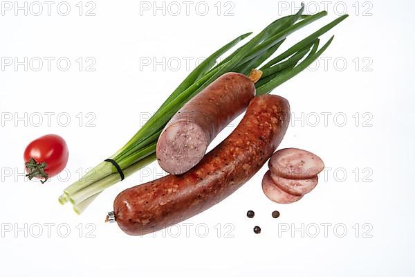 Sausage and greenery on an isolated studio background