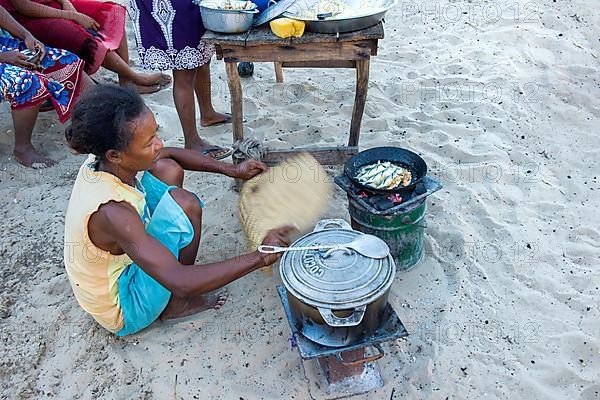 Malagasy woman cooking outdoors