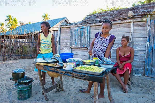 Malagasy woman cooking outdoors