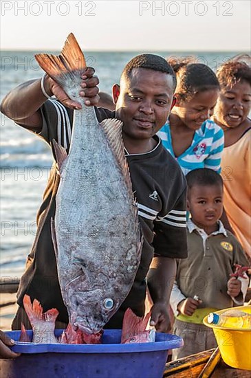 Malagasy fisherman showing his catch