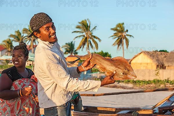 Malagasy fisherman showing his catch