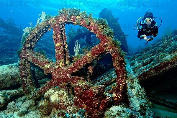 Diver on wreck with wheel of steel