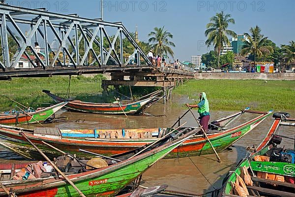 Colourful traditional longtail boats on the Yangon River