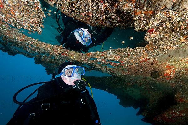 Diver reflected in bubble in a cave