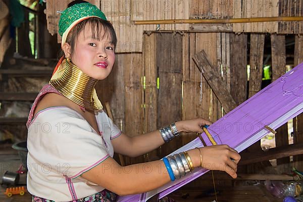 Long-necked woman weaving