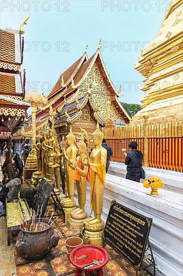 Worshippers walking around the Golden Chedi at Wat Doi Suthep