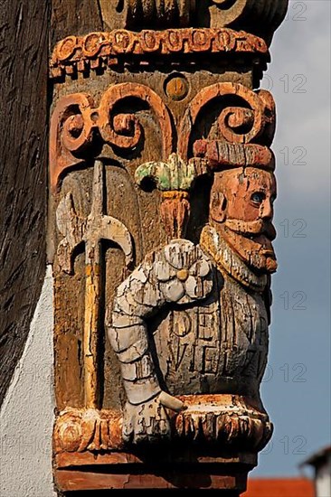 Artful carvings on corner beams of half-timbered house