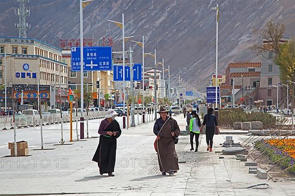Tibetan woman in traditional dress wear masks to protect themselves from pollution in Yushu city