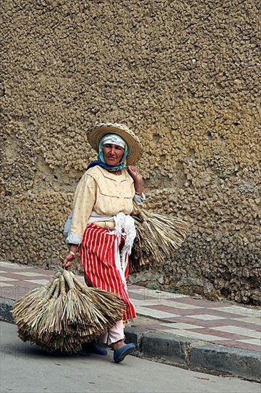 Old Berber woman carrying goods to market in Tetouan