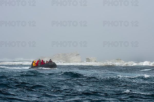 Zodiac with tourists approaching Herald Island