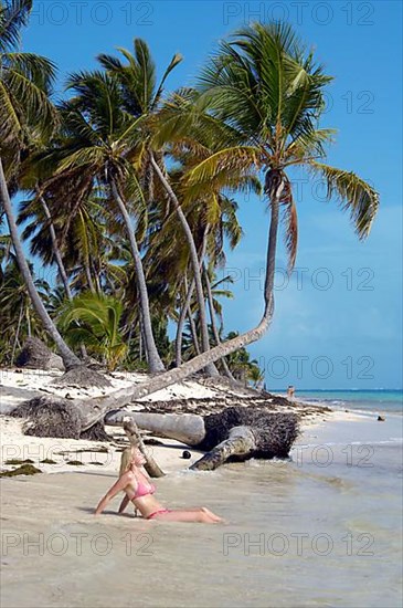 Woman on the beach with palm trees