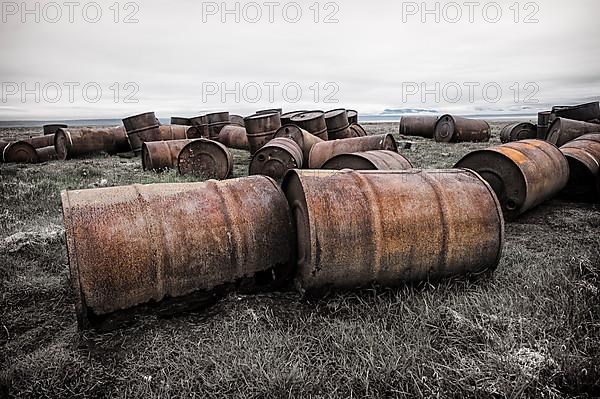 Rusted barrels in the tundra