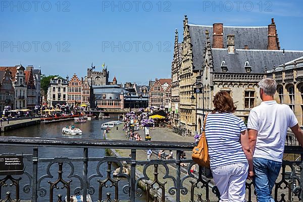 Tourists look from St. Michael's Bridge at the medieval houses along Graslei
