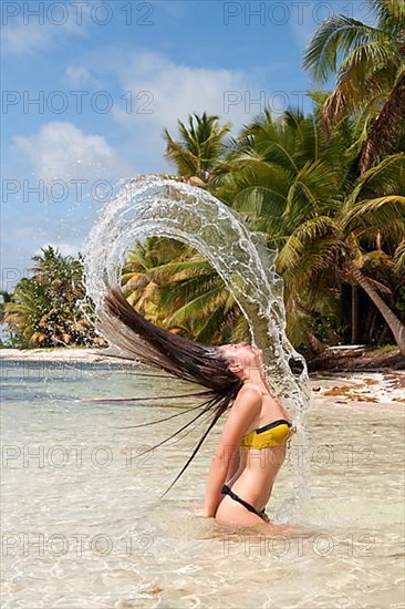 Young woman throws back her hair