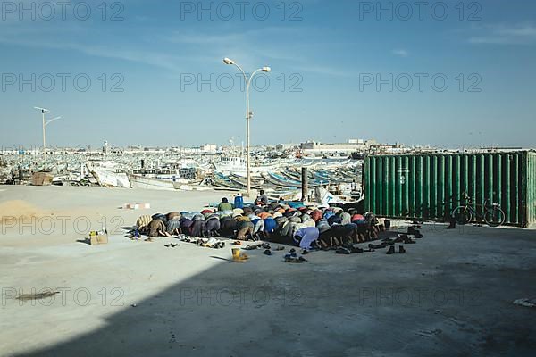 Dockworkers at evening prayer