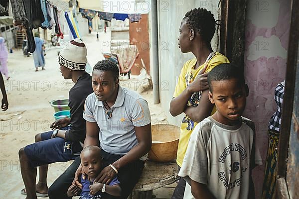 Fisherman and Captain Mukhtar in his house with various family members