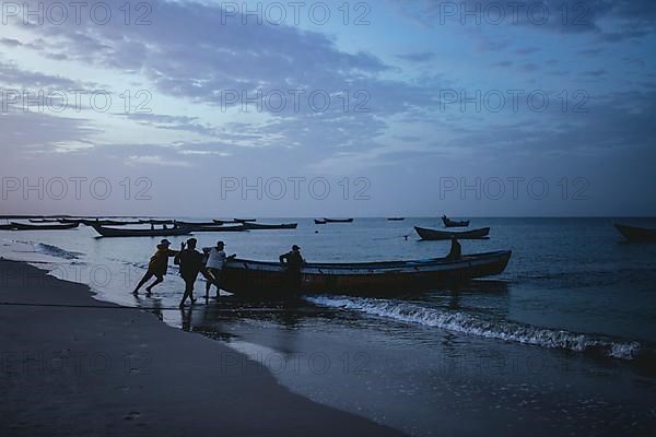 Fishing boats set sail at dawn