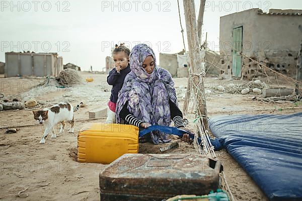 Woman filling drinking water into a canister