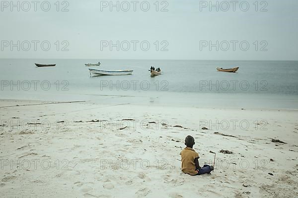 Waiting for the return of the fishing boats around noon on the beach