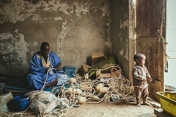 Fishermen mending nets in Nouamghar