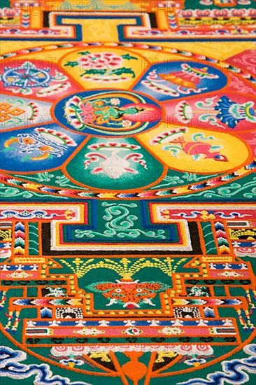 Symbols on temporary sand mandala in San Diego