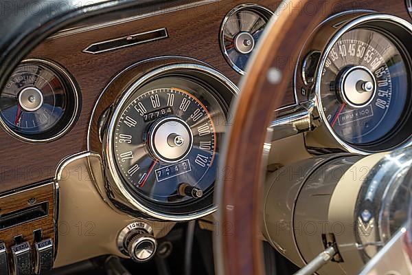 Speedometer of a Ford Mustang classic car with steering wheel. Gechingen