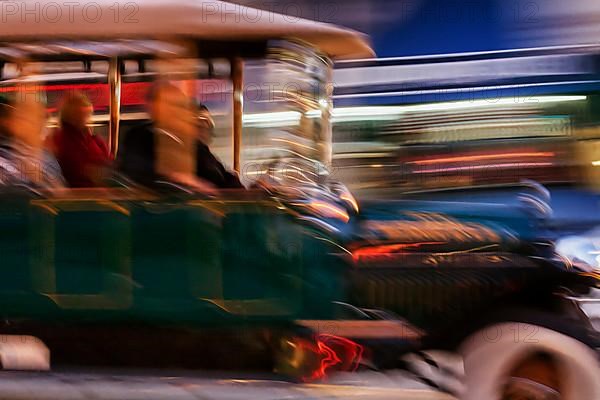 Tourists driving in a vintage car through downtown San Francisco