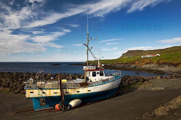 Fishing boat and farm at Hafnarholmi harbour