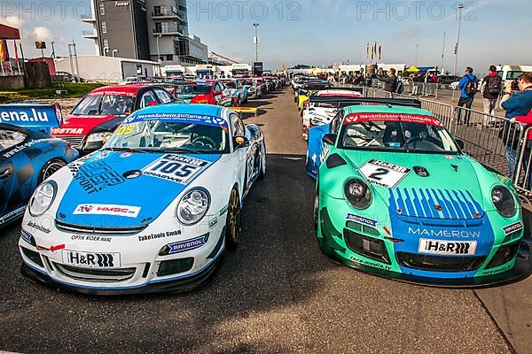 Racing car left Porsche Cayman R right 911 GT3 RSR in Parc Ferme