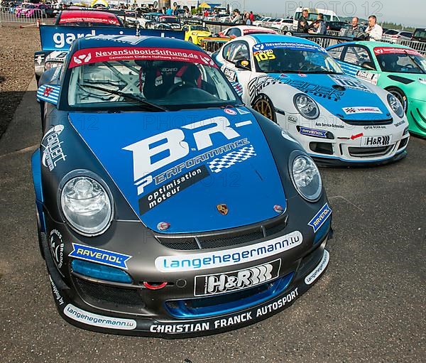 Racing car Porsche 911 GT3 right behind Porsche Cayman R in Parc Ferme